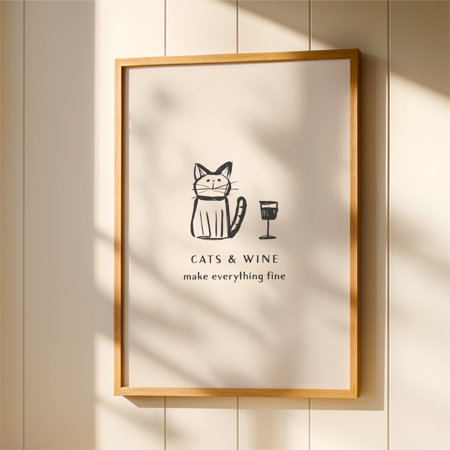 a framed poster with a cartoon cat and a wine glass, accompanied by the text "CATS & WINE make everything fine".