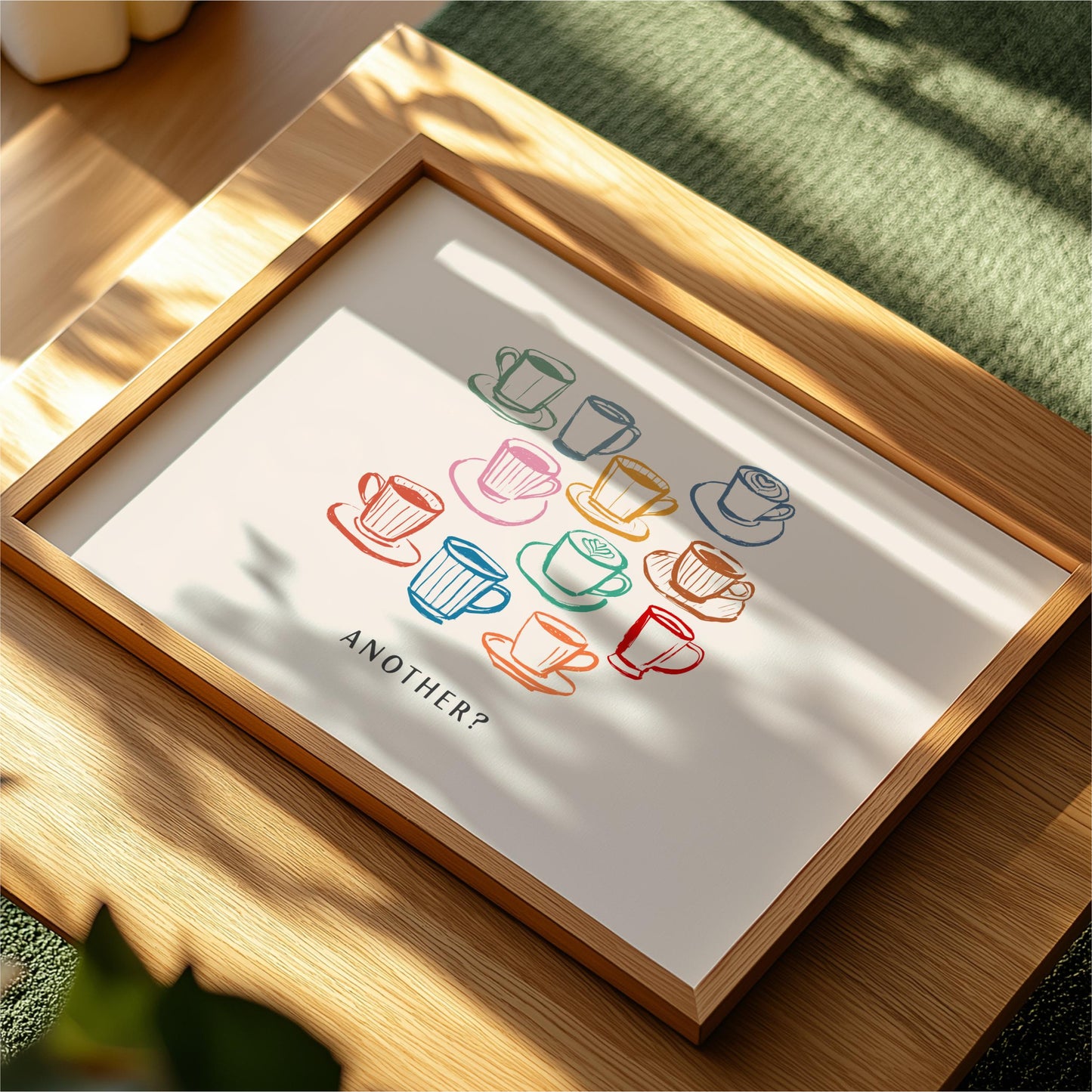 a framed artwork with a collection of colorful coffee cups and saucers, along with the text "ANOTHER?" displayed on the artwork.