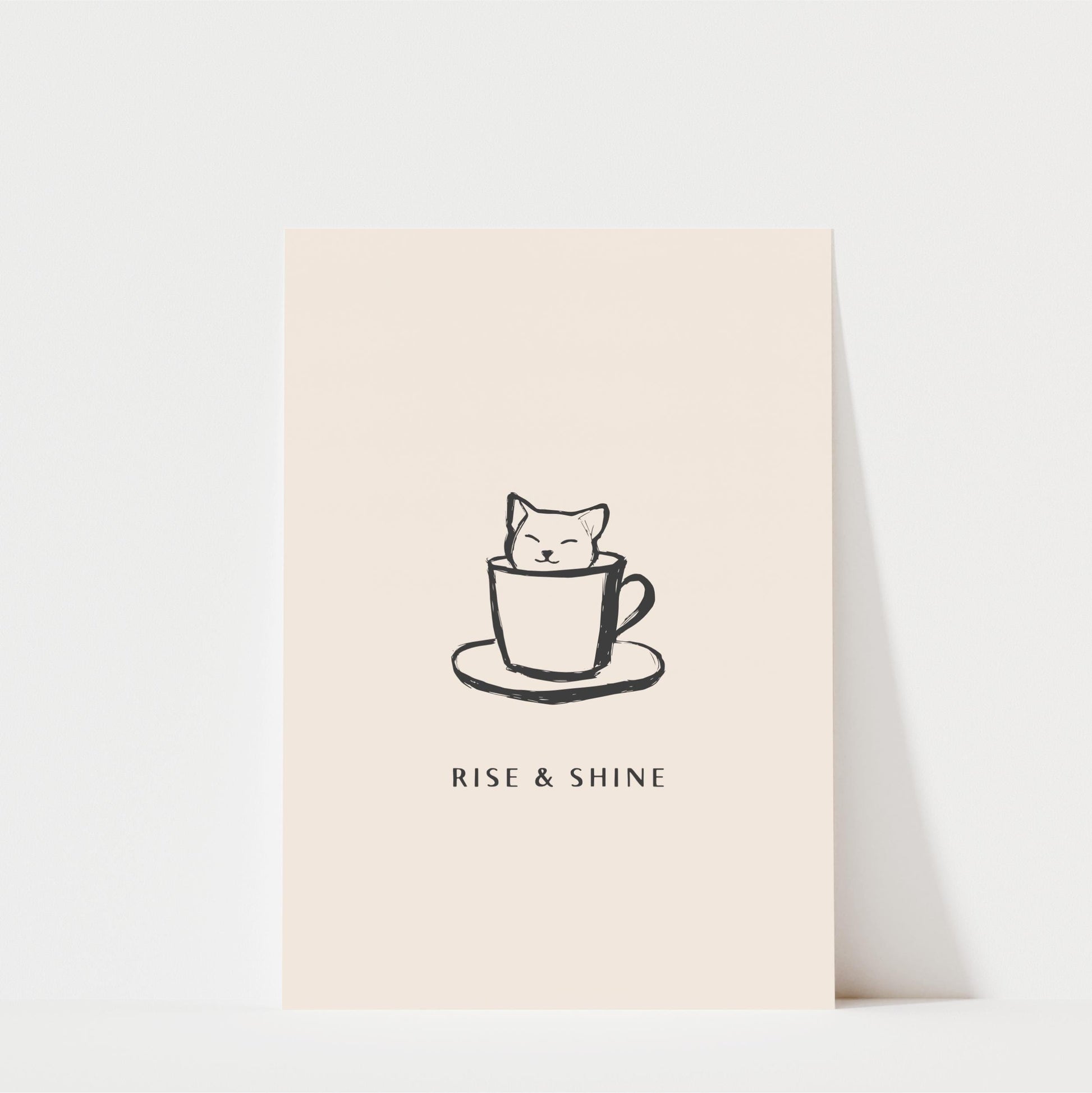 A simple black and white illustration of a cat sitting inside a coffee cup, accompanied by the text "RISE & SHINE" below the image.
