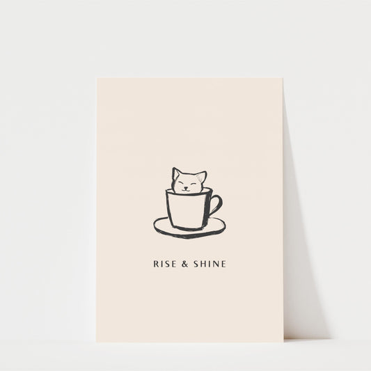 A simple black and white illustration of a cat sitting inside a coffee cup, accompanied by the text "RISE & SHINE" below the image.