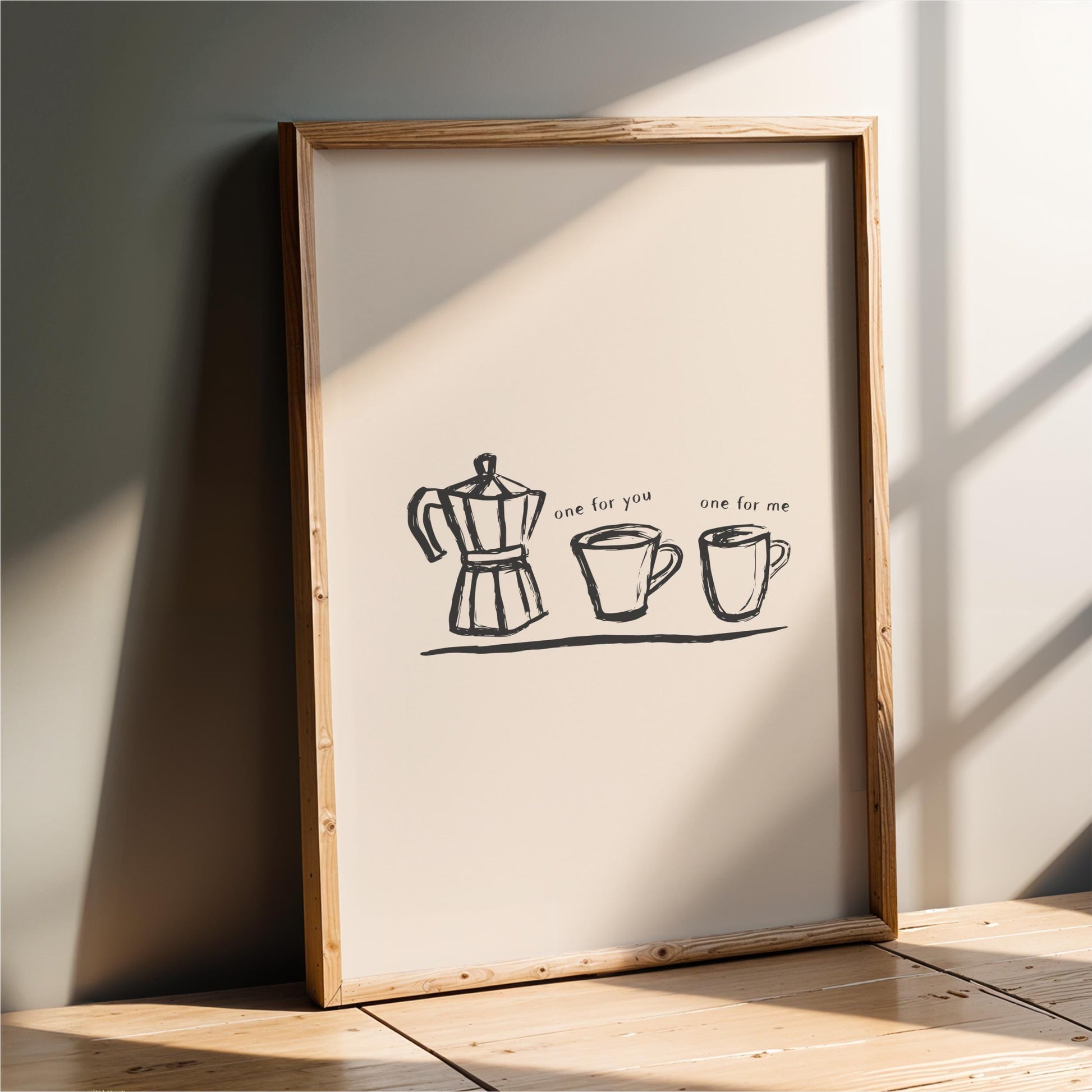 a framed poster with a simple black and white illustration of a coffee maker and two cups, accompanied by the text "one for you one for me".