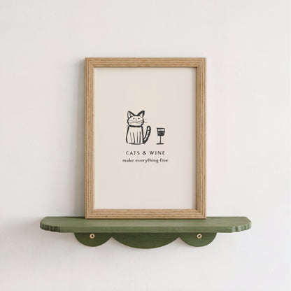 a framed poster with a cat and a wine glass, accompanied by the text "CATS & WINE make everything fine".
